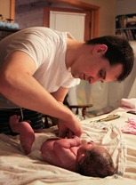 Daddy putting on her first diaper.  :)
